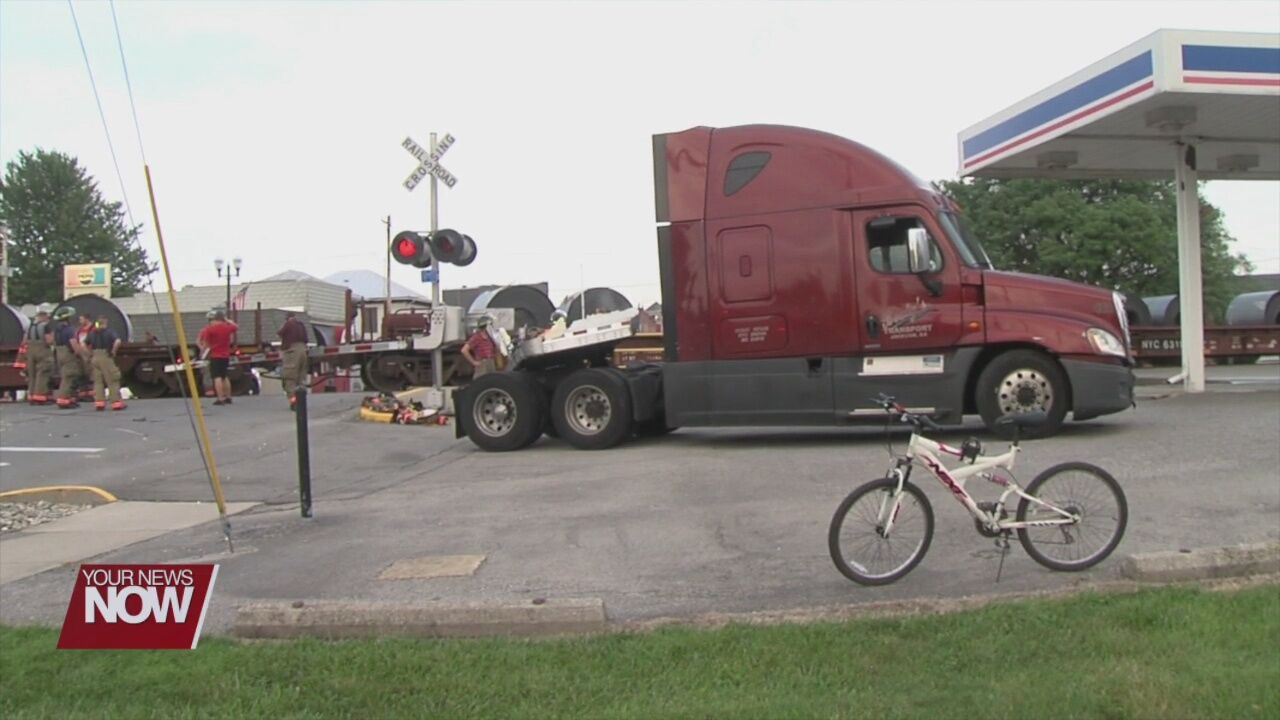 Train plows into semi, no one injured